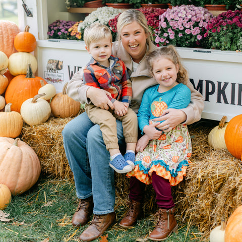 Woman with two children in a pumpkin patch