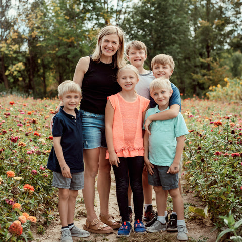 Woman with five children standing in a field of flowers