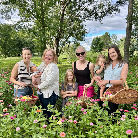 Group of women with children in a garden setting
