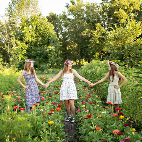 Friends wearing handmade floral crowns during a summer flower workshop in Oconomowoc Wisconsin.