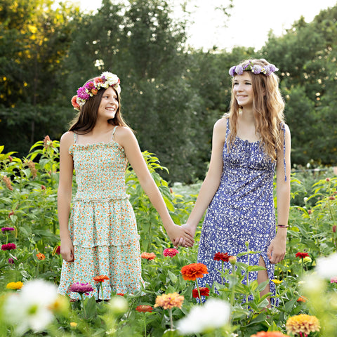 Guest wearing a handmade flower crown in the flower fields at First Roots Farm during a summer flower crown class.